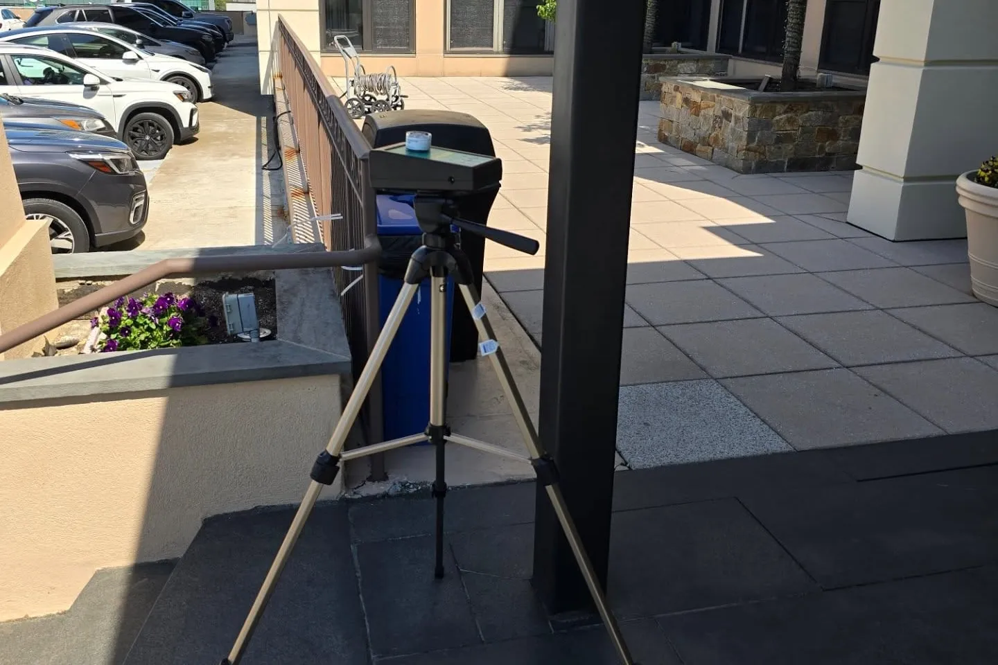 Air sampling pump on a tripod collecting an outdoor comparison sample during a mold assessment